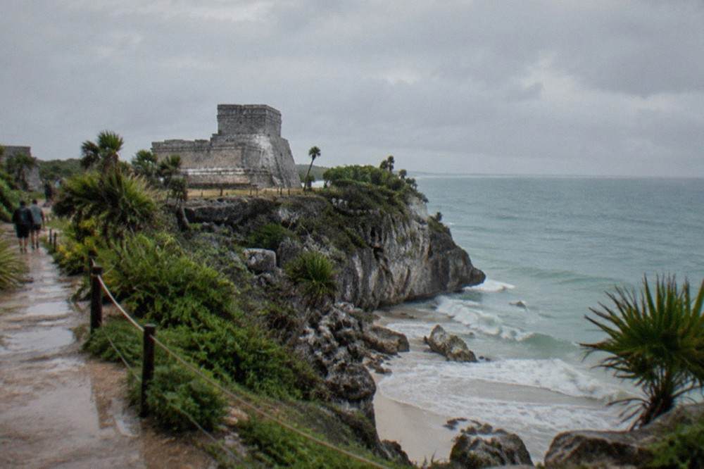 El Castillo temple pyramid on a cliff edge above turquoise Caribbean water