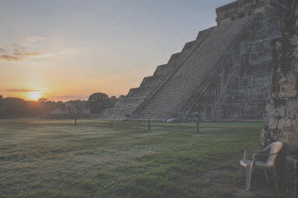 A quiet stone pyramid base in early morning light before the day's crowds arrive