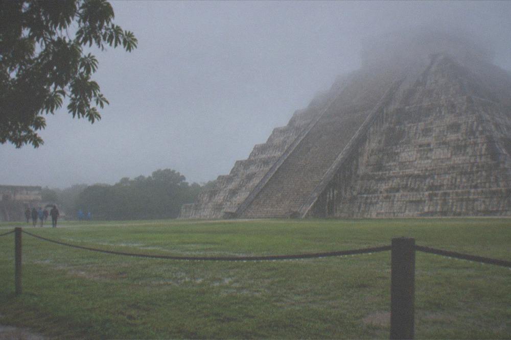 A low rope barrier in front of the stepped stone base of El Castillo at Chichen Itza