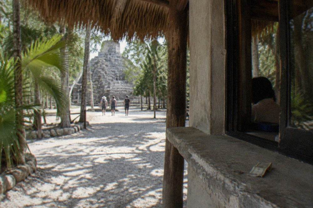 Ticket booth and shaded entrance path at the Coba archaeological site