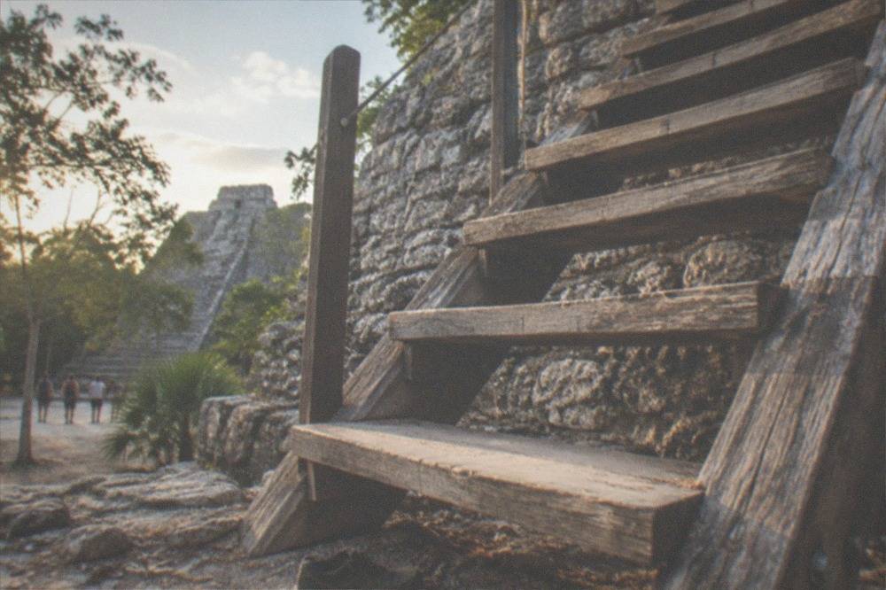 Wooden staircase ascending the stone face of the Nohoch Mul pyramid