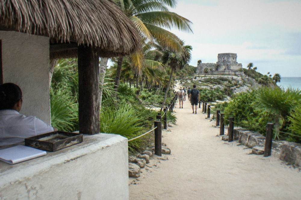 A ticket booth and shaded walkway at the entrance to an archaeological site